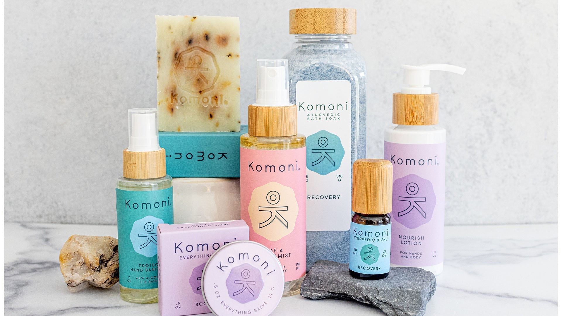 A beautiful display of of some of Komoni's offerings of aromamists, salves, essential oils, bath soaks, and cleanser bars, shampoo bars, and hand sanitizers.