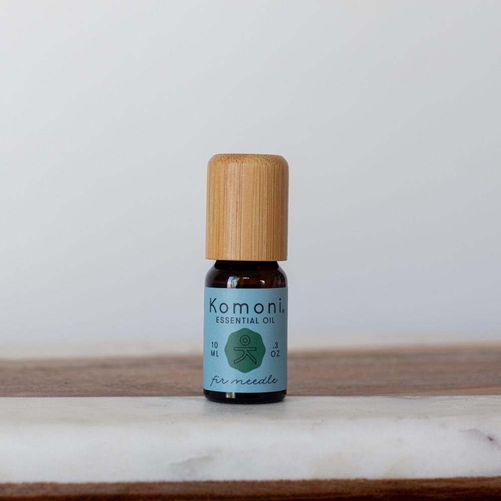 A 10ml vial of Fir Needle pure essential oil with attractive bamboo wood top offers a grounding, woody solution to promote calm and relaxation.