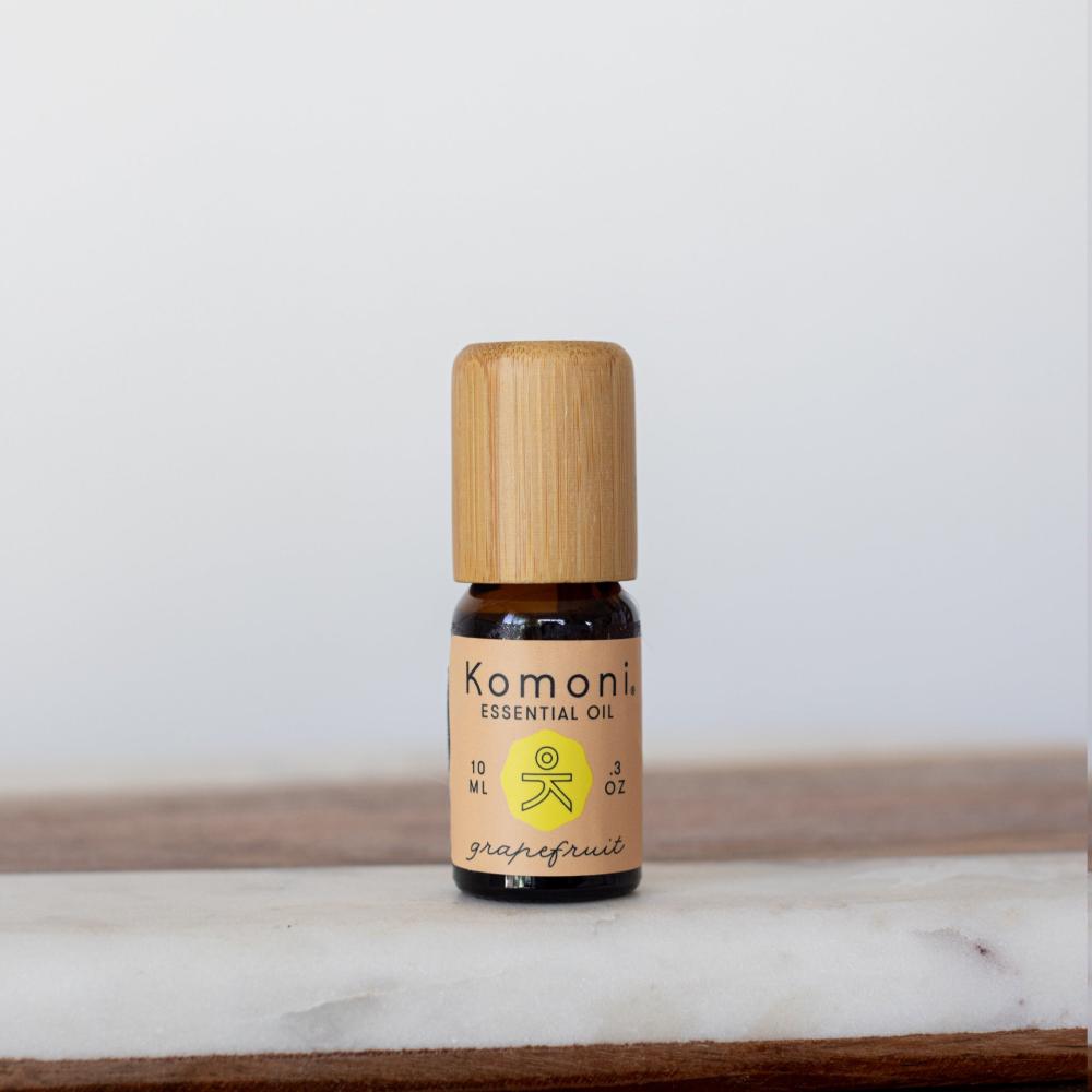 A 10ml vial of Grapefruit pure essential oil with attractive bamboo wood top offers an uplifting, natural remedy known for its fresh, sweet-tangy scent that promotes happiness and well-being while supporting skin health.