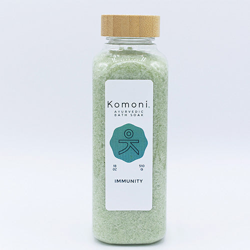 Light green crystals of IMMUNITY Bath Soak in 18 oz. clear plastic bottle with bamboo wood top.