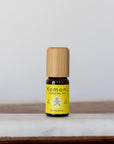 A 10ml vial of Lemon pure essential oil with attractive bamboo wood top offers a bright, uplifting scent that promotes happiness and well-being. Supports oily skin and a healthy complexion.