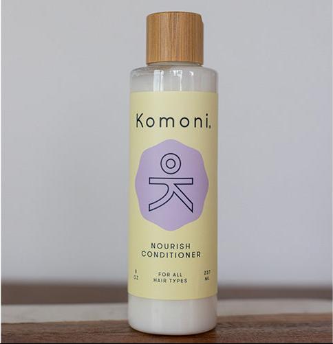 8 oz. pastel yellow bottle of Nourish lavender essential oil conditioner for all hair types.