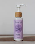 Wood top 4 oz. pastel purple pump-bottle of NOURISH Pure Botanicals & Essential Oils body lotion.