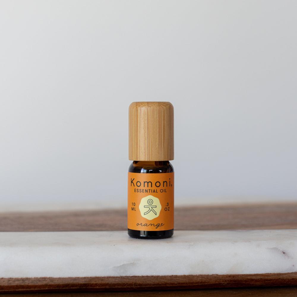 A 10ml vial of Orange pure essential oil with attractive bamboo wood top. Cold pressed for potency to reduce stress, enhance focus, or brighten your skin.