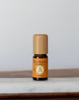 A 10ml vial of Orange pure essential oil with attractive bamboo wood top. Cold pressed for potency to reduce stress, enhance focus, or brighten your skin.