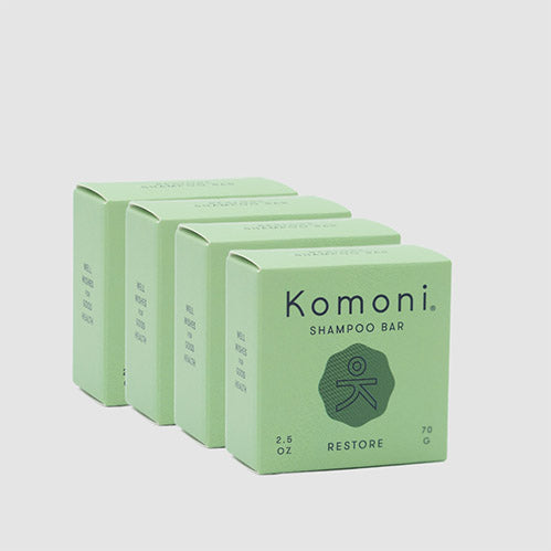 4 RESTORE concentrated eco-friendly essential oil shampoo bars shown in a row of pastel green boxes.