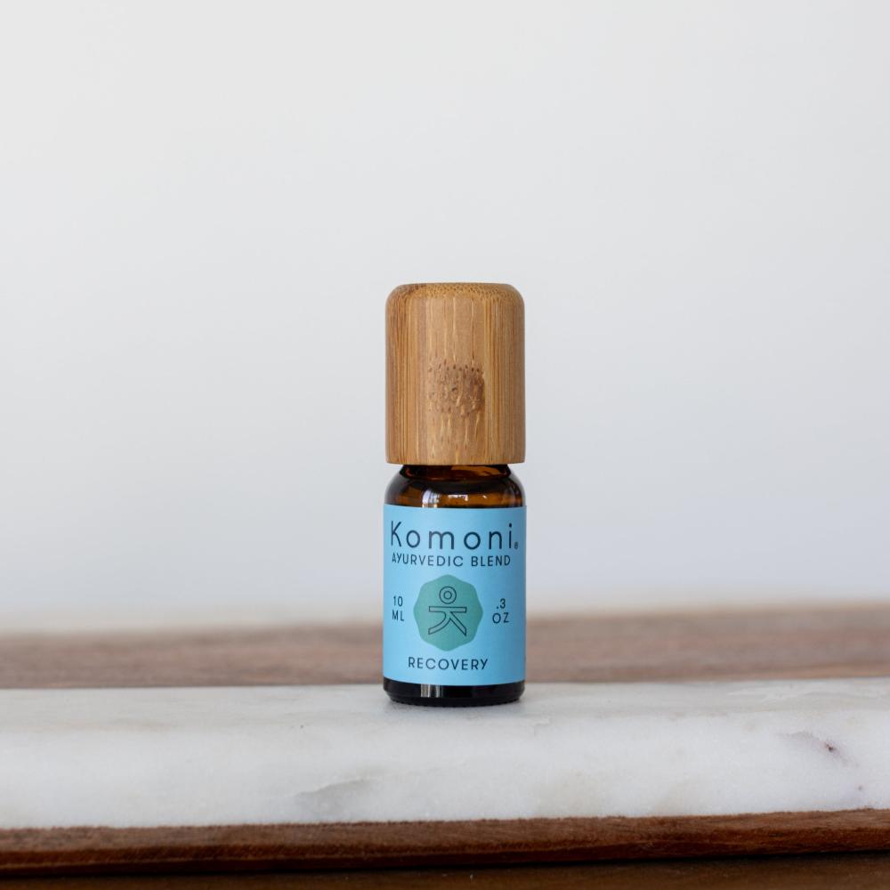 Recovery Ayurvedic proprietary blend of pure essential oils in 10 mL bottle with bamboo wood top soothes muscle aches and promoted healing with lavender, peppermint, rosemary, and wintergreen.