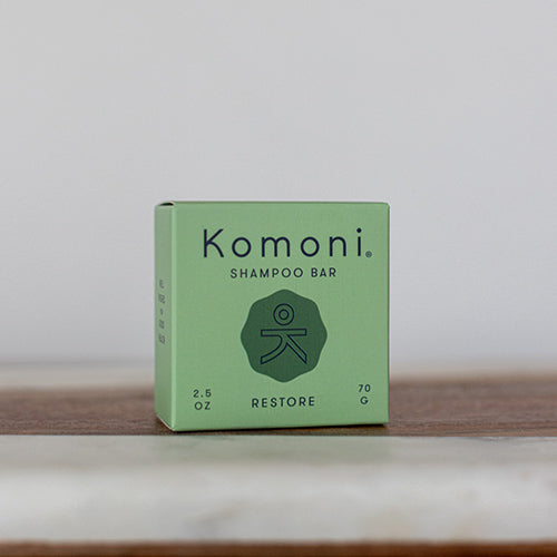 RESTORE concentrated eco-friendly essential oil shampoo bar shown in pastel green box.