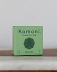 RESTORE concentrated eco-friendly essential oil shampoo bar shown in pastel green box.