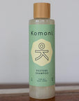 8 oz. pastel green bottle of Restore Rosemary-Mint-Sage botanical essential oil shampoo for all hair types.