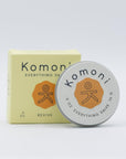 Lemongrass and Orange essential oil REVIVE everything lips, hands, skin salve shown in tin in front of box. Offers a nourishing blend of beeswax, organic sunflower oil, and shea butter. 