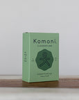 4 oz. Rosemary mint essential oil face & body cleanser bar shown in pastel green box. 