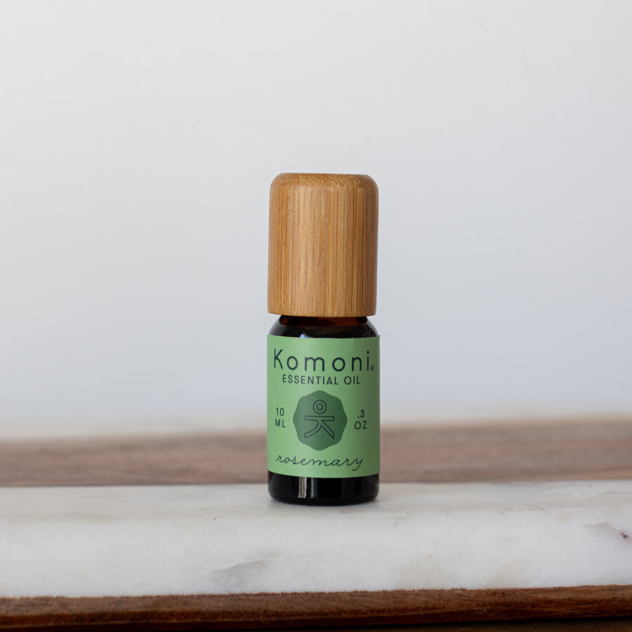 Rosemary pure essential oil in 10 mL bottle with bamboo wood top.