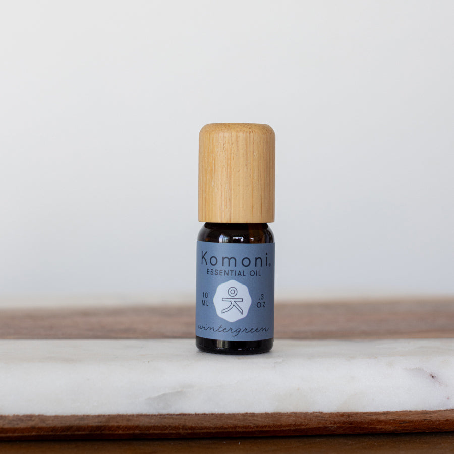 Wintergreen pure essential oil in 10 mL bottle with bamboo wood top.