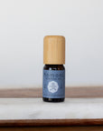 Wintergreen pure essential oil in 10 mL bottle with bamboo wood top.