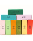 Colorful retail packaging of face & body cleaners bars stacked like blocks.