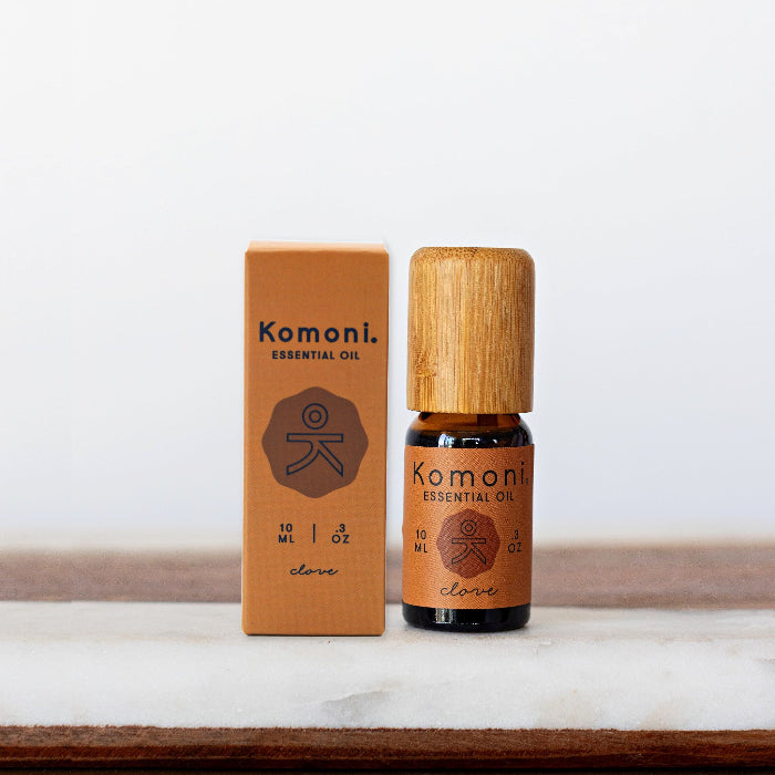 A 10ml vial of Clove pure essential oil with attractive bamboo wood top next to box packaging.