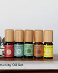 Immunity Pure Essential Oil Set of 5: Cinnamon, eucalyptus, rosemary, clove, and lemon in 10 mL vials with bamboo wood tops. 