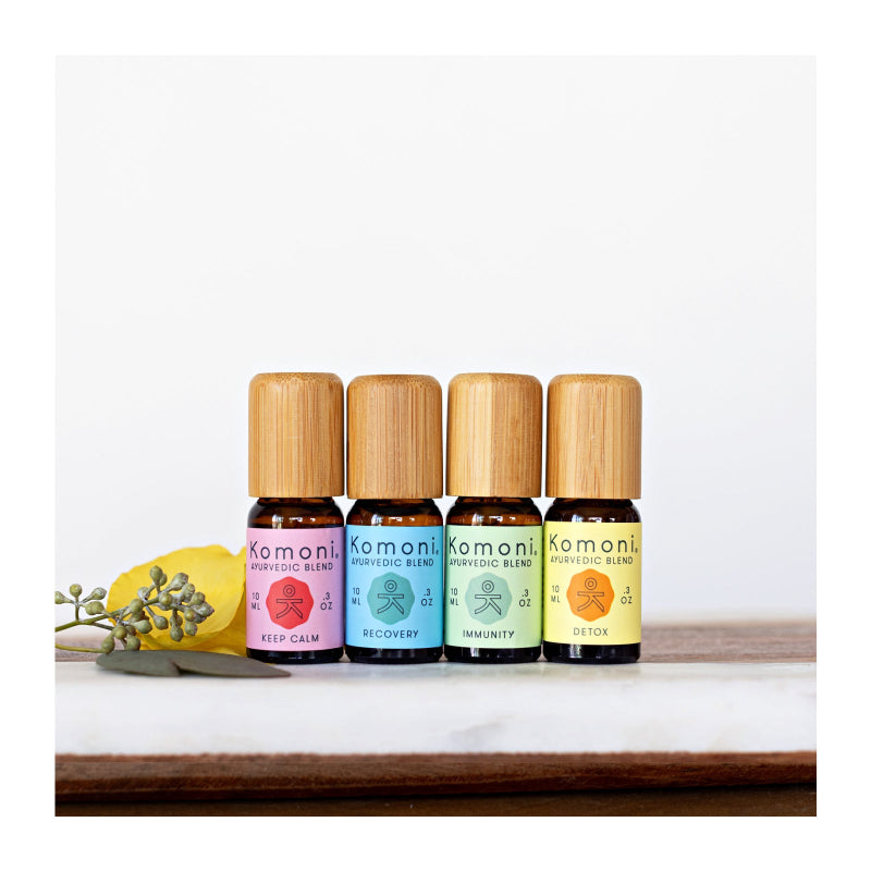 1 of each of the four Komoni signature essential oil ayurvedic blends in 10 mL bottles with bamboo wood tops. 