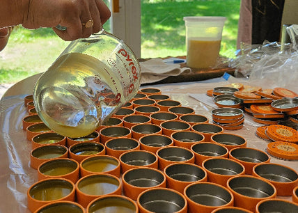 Filling the tins of handcrafted Everything Salves. 