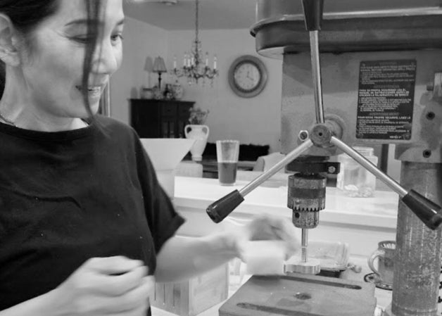 Founder Evangeline Stacy hand pressing Komoni logo into the freshly cut bars of shampoo bars.