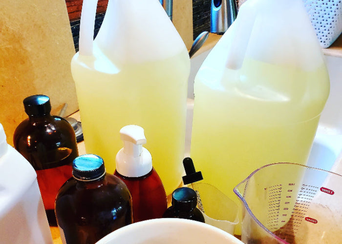 Bottles of various sizes of pure, natural ingredients being used to create small batch signature wellness products. 