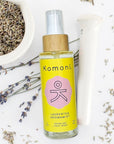 4 oz. spray bottle of Laurentha Aromamist in front of plant-based ingredients.