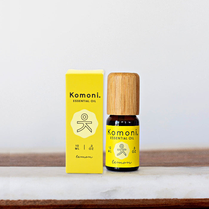 A 10ml vial of Lemon pure essential oil with attractive bamboo wood top next to box packaging.