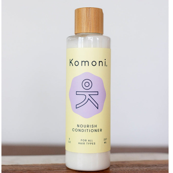 8 oz. pastel yellow bottle of Nourish lavender essential oil conditioner for all hair types.