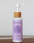 Wood top 4 oz. pastel purple pump-bottle of NOURISH pure botanicals & essential oils body lotion.