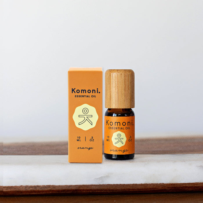 A 10ml vial of Orange pure essential oil with attractive bamboo wood top next to box packaging.