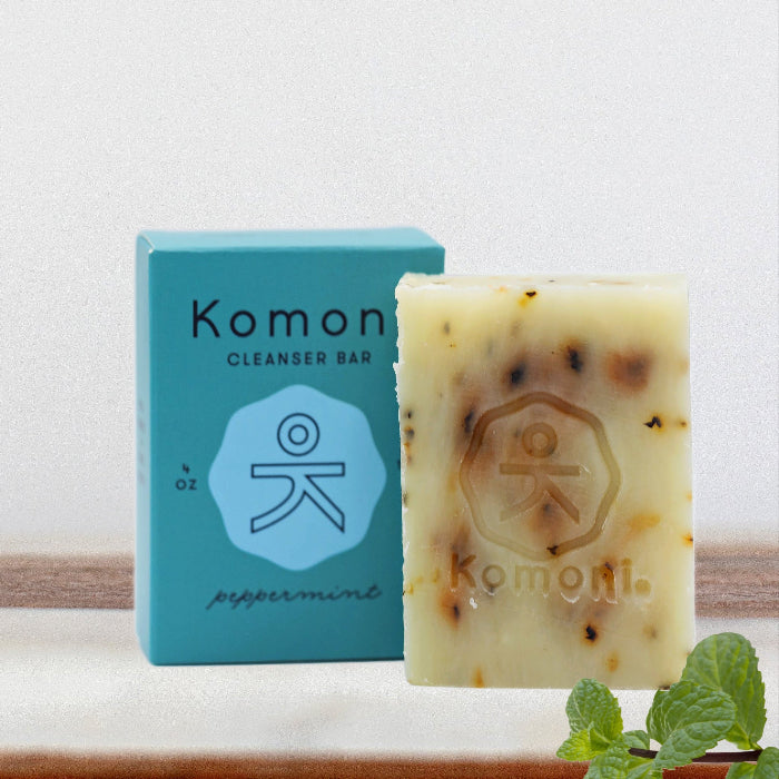 Peppermint essential oil face & body cleanser bar shown in front of sea-foam blue box packaging.