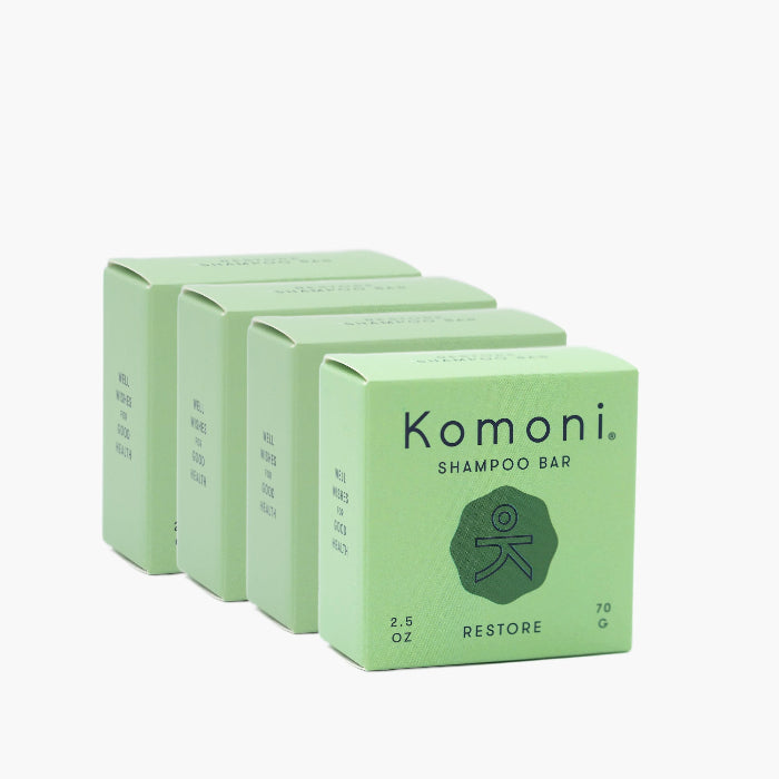 4  pastel green boxes of RESTORE concentrated eco-friendly essential oil shampoo bars. 