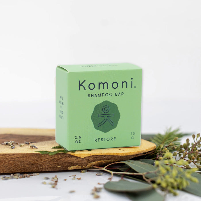 RESTORE concentrated eco-friendly essential oil shampoo bar shown in pastel green box.