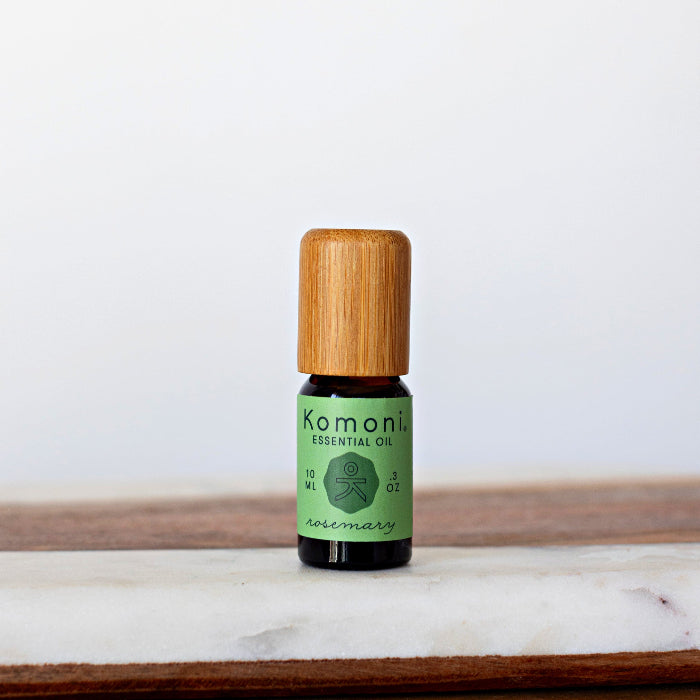 Rosemary pure essential oil in 10 mL bottle with bamboo wood top.