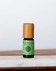 Rosemary pure essential oil in 10 mL bottle with bamboo wood top.