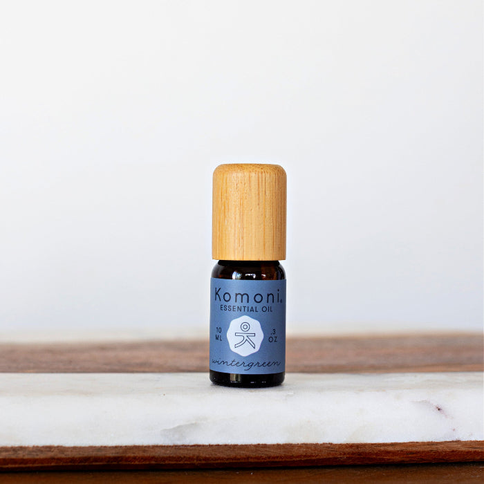 Wintergreen pure essential oil in 10 mL bottle with bamboo wood top.